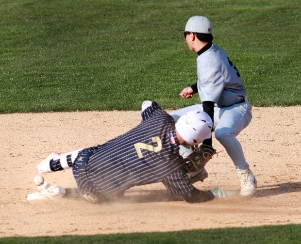 Lemont's Brett Tucker slides in second safe during the baseball against Richards in Lemont on Thursday, April 10, 2025. (James C. Svehla / for the Daily Southtown)
