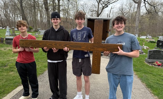 Hayden Strodick, from left, Caleb Strahanoski, Liam Doyle and Luke Strahanoski carry the cross during April 18, 2025, in New Lenox. (Jeff Vorva/for the Daily Southtown)