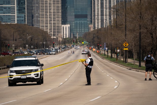 Police investigate the scene April 6, 2021, where evidence was found near the 1000 block of South Lake Shore Drive in Chicago following a shooting in which a young boy was wounded. (E. Jason Wambsgans/Chicago Tribune)
