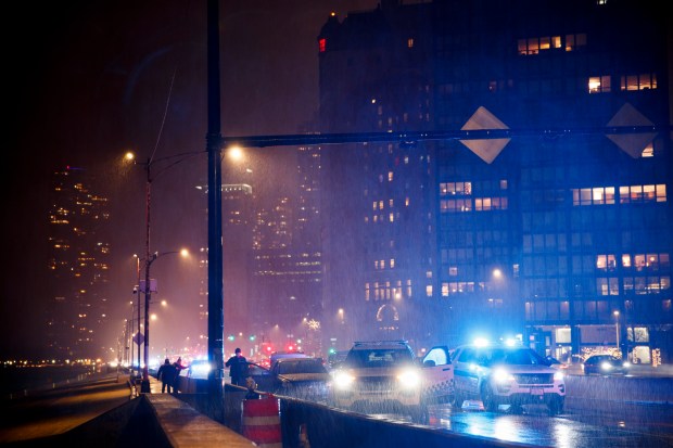 Police work the scene where a 18-year-old man was shot in a vehicle on the 800 block of DuSable Lake Shore Drive, Dec. 14, 2021. (Armando L. Sanchez/Chicago Tribune)