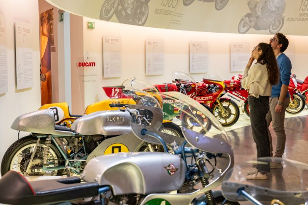 Visitors look at racing bikes on display at the Ducati Museum in Bologna, Italy, in Feb. 2025. (Federico Borella/The New York Times)