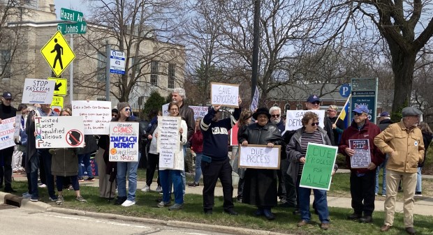 People line the street in front of Highland Park City Hall to protest Trump administration policies. (Steve Sadin for the Lake County News-Sun)