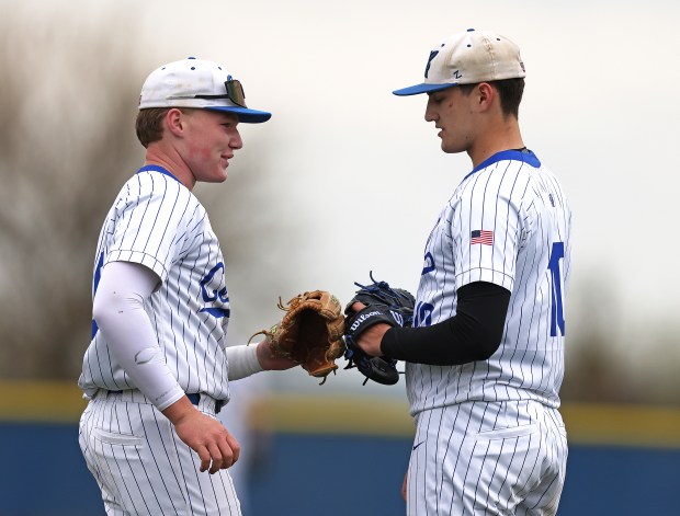 Burlington Central's Liam Schultz (35) and Chase Powrozek (10) slap gloves after a stike out in the first inning against Jacobs during a Fox Valley Conference game in Burlington on Wednesday, April. 30, 2025.(H. Rick Bamman / The Beacon-News)