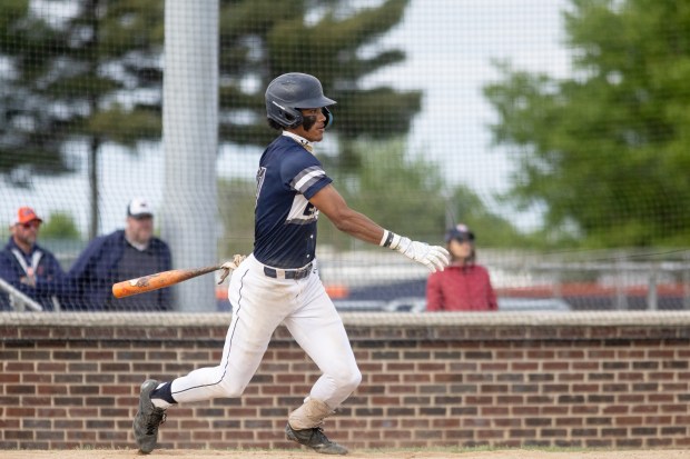 Oswego East's Jacsen Tucker (17) hits the ball against Oswego during a Southwest Prairie Conference game in Oswego on Thursday, May 22, 2025. (Troy Stolt for the Beacon News)