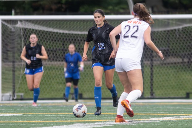 St. Charles North's Madisen Shanahan (12) dribbles down field against Wheaton Warrenville South during the Class 3A Glenbard West Sectional final in Glen Ellyn on Friday, May 30, 2025. (Troy Stolt for the Beacon News)