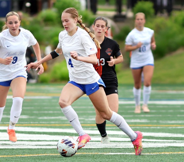 St. Charles North's Kaitlyn Nudera moves the ball as St. Charles East defends during the Class 3A Glenbard West Sectional semifinal soccer game in Glen Ellyn on Tuesday, May 27, 2025.(James C. Svehla / for the Beacon-News)