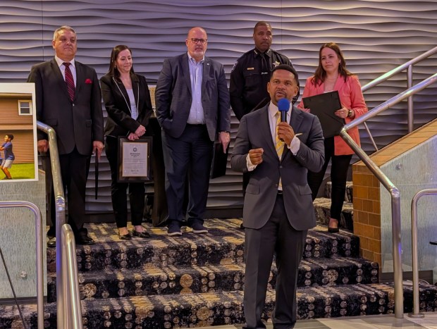 Richard Irvin, surrounded by those in his mayor's office who were set to leave at the same time as him, speaks at an event held at Copley Theatre in Aurora on May 6. (R. Christian Smith / The Beacon-News)