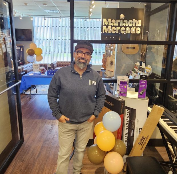 Harley Figueroa of Berwyn, director of scholastic programs at PM Music Center, stands outside the new showroom showcasing mariachi music at the store in Aurora. (David Sharos / For The Beacon-News)