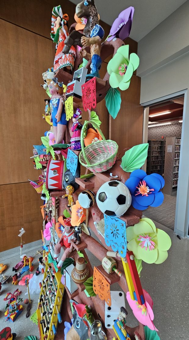 A paper mache tree created by Maria Valenzuela of Chicago showcasing Mexican toys is on display at the Santori Public Library in downtown Aurora through May 30 and is expected to draw as many as 3,000 viewers during its run. (David Sharos / For The Beacon-News)