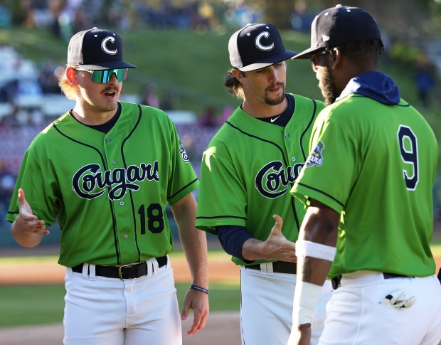 Kane County Cougars' Westin Muir (18), left, greets teammates during introductions before the home opener against the Sioux City Explorers at Northwestern Medicine Field on May 8, 2025 in Geneva. Muir attended St. Charles North High School.(H. Rick Bamman / The Beacon-News)