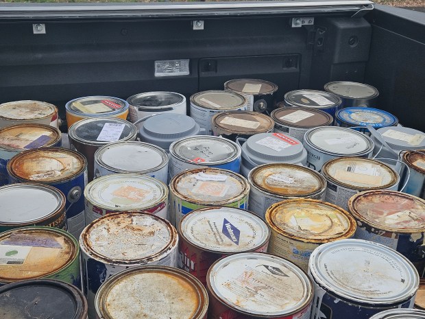 Jeff Lange of Elgin brought a number of paint cans to be recycled during a Kane County recycling event Saturday in St. Charles. (David Sharos / For The Beacon-News)
