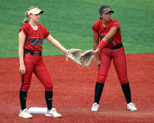 Yorkville's Bella Phillips (11) and Liv Lathen (5) slap gloves at the start of the fifth inning against Waubonsie Valley during the Class 4A Yorkville Regional semifinal in Yorkville on Tuesday, May 27, 2025.(H. Rick Bamman/for the Beacon-News)