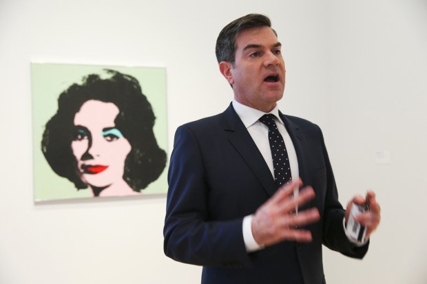 The Art Institute's James Rondeau talks about the donation of paintings, including the Warhol behind him, in 2015.