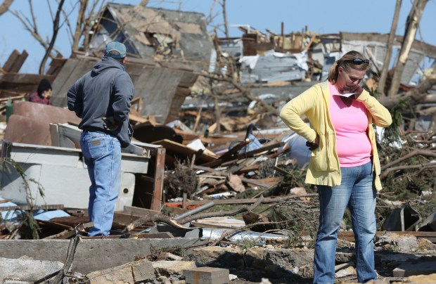 Donna Peek pauses while searching for items at what was her mother Jacklyn K. Klosa's home in Fairdale, April 11, 2015. Klosa was one of two people killed during a tornado that caused major damage to most the town Thursday night. (John J. Kim/Chicago Tribune)