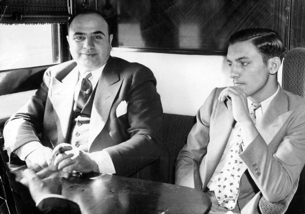 Convicted Chicago Outfit leader Al Capone and a fellow prisoner (not related to Capone's case) on board a train in May 1932, en route to Atlanta, Ga., from Chicago. Both were on their way to serve sentences, Capone for income tax evasion and his berth mate for auto theft. (Chicago Tribune archive)