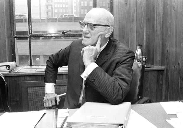 With a book of plays in front of him, George Halas, head coach of the Chicago Bears for 39 years, tells newsmen of his retirement on May 27, 1968. Halas retired before, in 1956, then returned to the helm. (Charles Knoblock/AP)