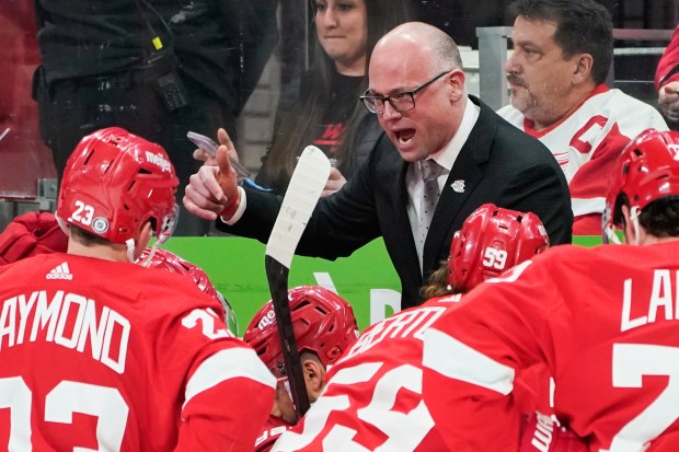 Red Wings coach Jeff Blashill talks to his team during a timeout against the Arizona Coyotes on March 8, 2022, in Detroit. (AP Photo/Paul Sancya)