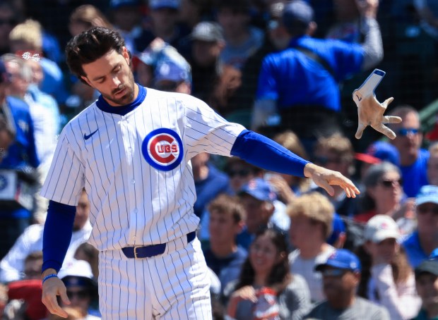 Cubs shortstop Dansby Swanson tosses his batting gloves after striking out against the Reds in the fourth inning May 31, 2025, at Wrigley Field. (John J. Kim/Chicago Tribune)