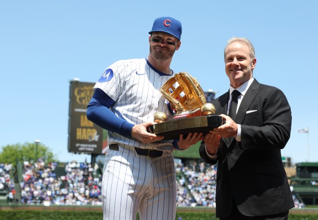 Cubs left fielder Ian Happ is presented with his Gold Glove Award before a game against the Reds on May 31, 2025, at Wrigley Field. (John J. Kim/Chicago Tribune)