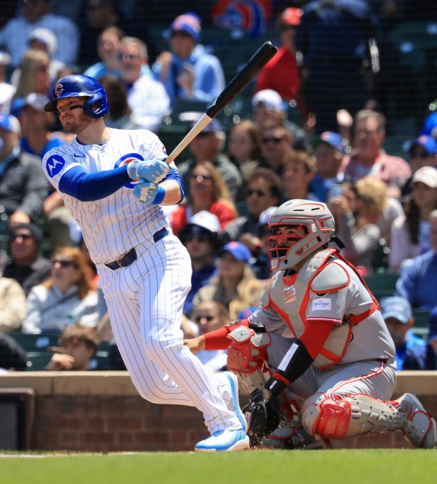 Cubs left fielder Ian Happ hits a double in the first inning against the Reds on May 31, 2025, at Wrigley Field. (John J. Kim/Chicago Tribune)