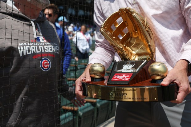 Cubs left fielder Ian Happ's Gold Glove Award is moved onto the field for a pregame ceremony May 31, 2025, at Wrigley Field. (John J. Kim/Chicago Tribune)
