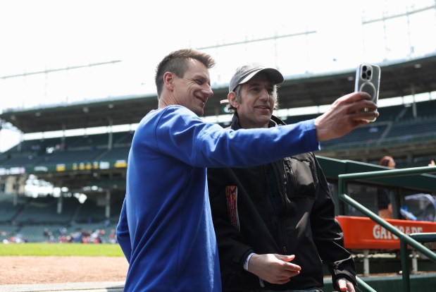 Cubs manager Craig Counsell, left, takes a picture with a friend before a game against the Reds on May 31, 2025, at Wrigley Field. (John J. Kim/Chicago Tribune)