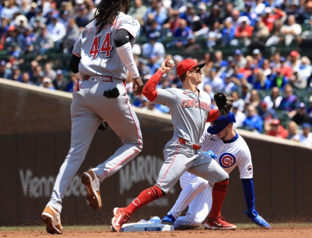 Reds second baseman Matt McLain throws to first for a double play after forcing out Cubs right fielder Kyle Tucker in the first inning May 31, 2025, at Wrigley Field. (John J. Kim/Chicago Tribune)