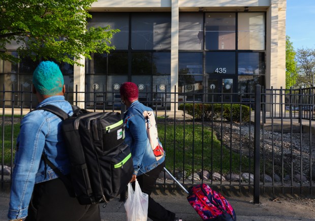 People walk past the congressional office of U.S. Rep. Jonathan Jackson at 435 E. 35th St., May 13, 2025, in Chicago. (John J. Kim/Chicago Tribune)