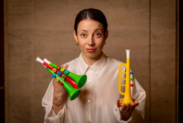 Cellist and composer Lia Kohl holds toy instruments on May 5, 2025, at Union Station, for her "Mars Williams' Toy Story," a tribute to the late saxophonist Mars Williams. (Brian Cassella/Chicago Tribune)