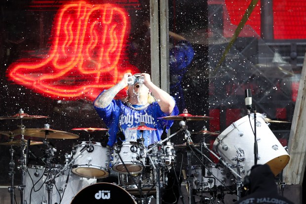Drummer Cody Ash chugs a beer while performing with Jelly Roll, May 22, 2025, in Chicago. The concert is Jelly Roll's first performance at Wrigley Field. (Armando L. Sanchez/Chicago Tribune)