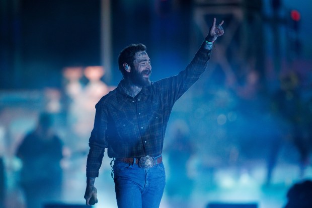Post Malone waves during his first ever performance at Wrigley Field on May 22, 2025, in Chicago. (Armando L. Sanchez/Chicago Tribune)