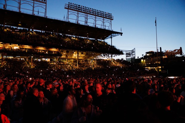 Fans watch Post Malone perform at Wrigley Field, May 22, 2025, in Chicago. The concert is Malone's first performance at Wrigley Field. (Armando L. Sanchez/Chicago Tribune)