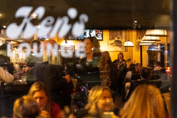 Shannon Ward performs at Ken's on Western as she is flanked by bar lights and patrons of this longtime-neighborhood establishment on Feb. 22, 2025. (Vincent D. Johnson/for the Chicago Tribune)