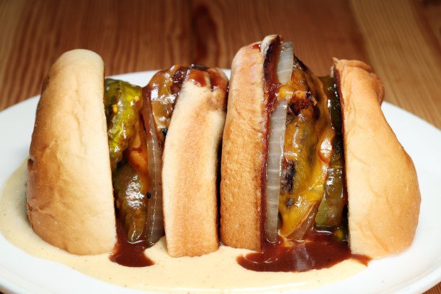 The Parachute cheeseburger at Parachute HiFi. It gets cut in half, placed cut side down in its own pool of cheese, plus a pour of bordelaise, the classic French red wine sauce typically reserved for steak. (Terrence Antonio James/Chicago Tribune)