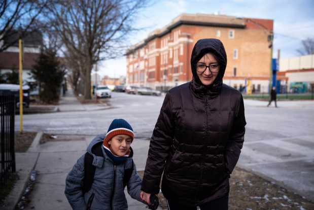 Mary, from Ecuador, whose last name wasn't provided, picks up her son Aaron, 9, after school from Hamline School in the Back of the Yards neighborhood, Jan. 27, 2025. On Jan. 24, two Secret Service agents appeared outside Hamline Elementary School and the district sparked a panic when it falsely proclaimed Immigration and Customs Enforcement agents had tried to enter the building. (E. Jason Wambsgans/Chicago Tribune)