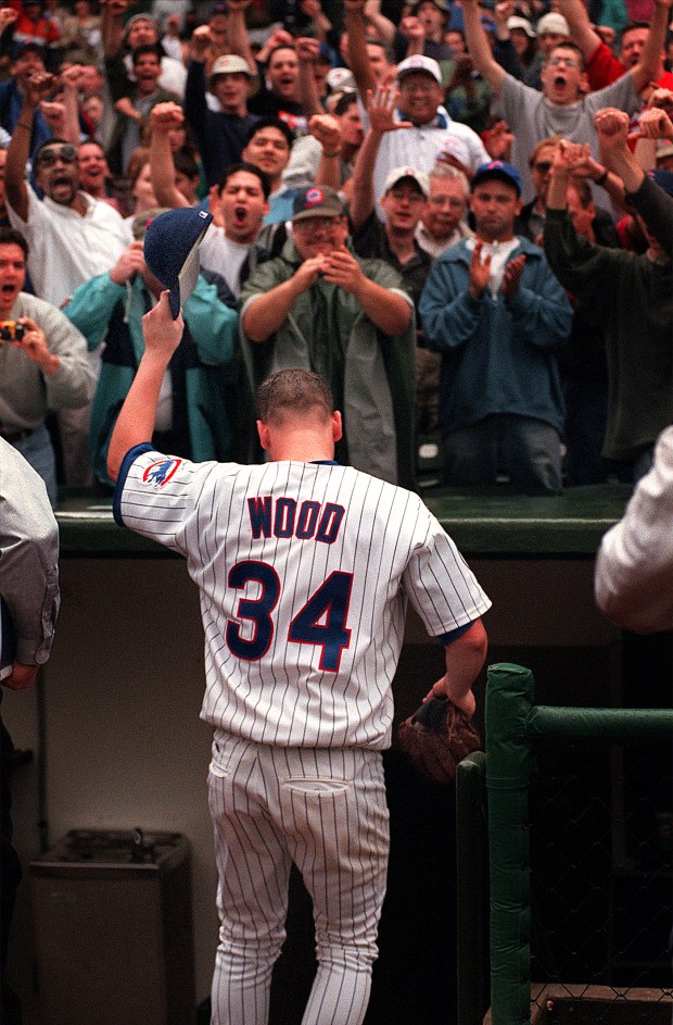Fans react during a Chicago Cubs game where Kerry Wood (34) pitched 20 strikeouts in a one-hit shutout against the Houston Astros on May 6, 1998, at Wrigley Field. (Heather Stone / Chicago Tribune)