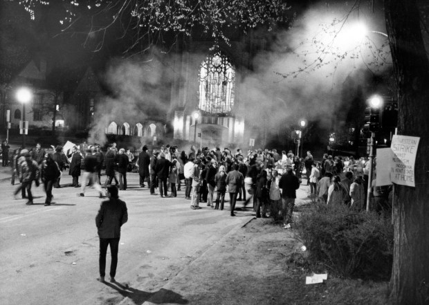 Students barricaded several blocks of Sheridan Road and built fires in the middle of the street using garbage and park benches for fuel on May 7, 1970, during an anti-war protest in solidarity with Kent State University. The stained-glass windows of Levere Memorial Temple can be seen in the background. (Charles Osgood/Chicago Tribune)