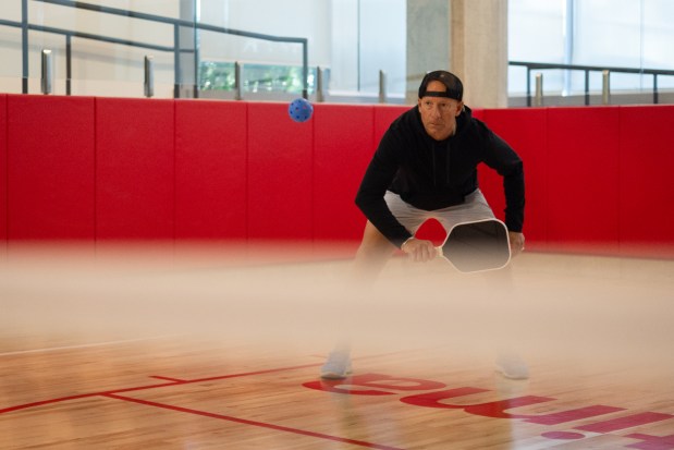 Johnny Forester, a resident at Optima Verdana apartment complex since May, 2024, plays pickleball with his wife and fellow residents on May 14, 2025, in Wilmette. (Audrey Richardson/Chicago Tribune)