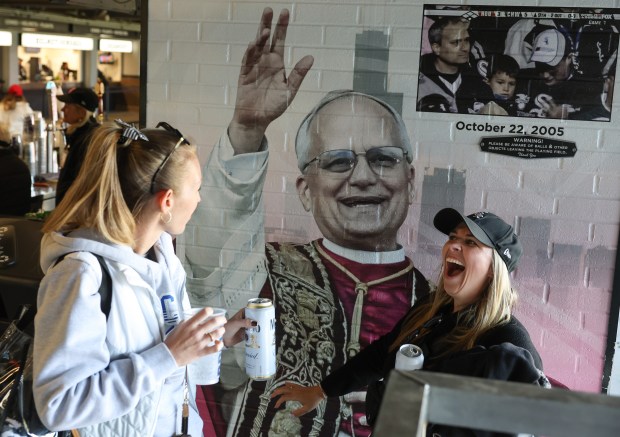 Andrea Burns, left, and Martina Maggiore find the recently installed mural of Pope Leo XIV in Section 140 before a White Sox-Rangers game at Rate Field on May 23, 2025. Chicagoans can buy tickets to a June 14 citywide celebration of Pope Leo XIV's election beginning Friday, the Archdiocese of Chicago announced. (John J. Kim/Chicago Tribune)