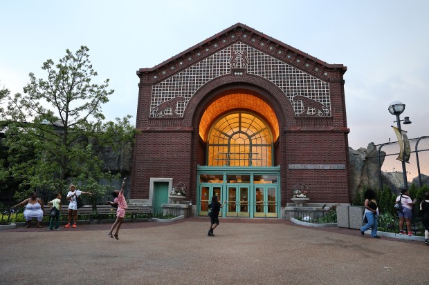 Children pass by the Pepper Family Wildlife Center as they run to get a look at lions as Chicago HOPES for Kids hosts an after-hours field trip to the Lincoln Park Zoo on May 15, 2025. (Chris Sweda/Chicago Tribune)