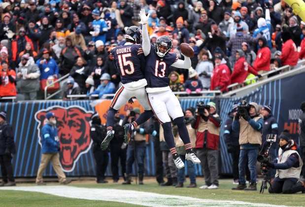 Chicago Bears wide receiver Keenan Allen (13) celebrates with teammate Rome Odunze (15) after Allen caught a touchdown pass from quarterback Caleb Williams in the second quarter of a game against the Detroit Lions at Soldier Field in Chicago on Dec. 22, 2024. (Chris Sweda/Chicago Tribune)