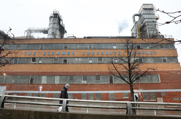A person walks past the Blommer Chocolate Company at 600 W. Kinzie St. in Chicago on March 22, 2024. The company plans to shut down the Chicago factory after 85 years. (Chris Sweda/Chicago Tribune)