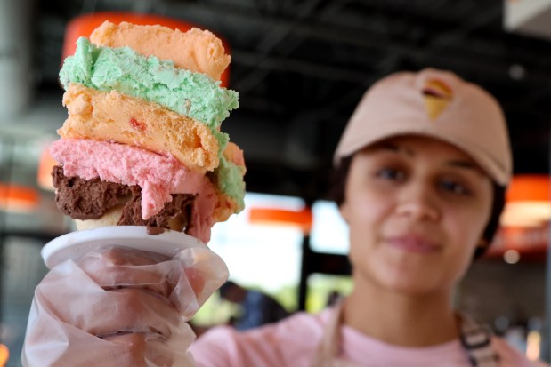 Guadalupe Garcia prepares an Original Rainbow Cone for a customer at the new Buona restaurant in Gurnee, May 16, 2025. (Antonio Perez/Chicago Tribune)
