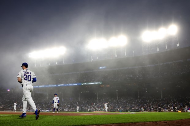 With heavy fog blanketing the area, Chicago Cubs right fielder Kyle Tucker (30) runs out to his position to start the seventh inning of a game against the Miami Marlins at Wrigley Field in Chicago on May 14, 2025. (Chris Sweda/Chicago Tribune)