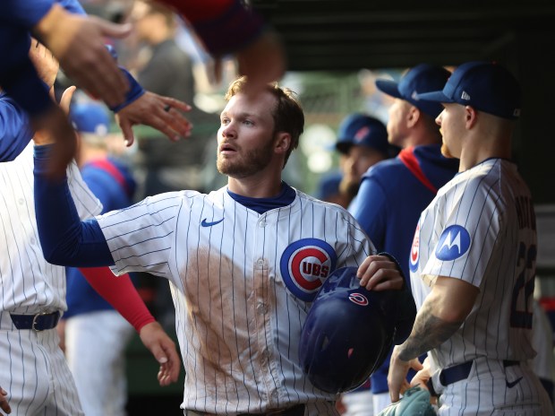 Chicago Cubs outfielder Ian Happ is congratulated in the dugout after scoring on a ground out by teammate Pete Crow-Armstrong in the third inning of a game against the Colorado Rockies at Wrigley Field in Chicago on May 27, 2025. (Chris Sweda/Chicago Tribune)