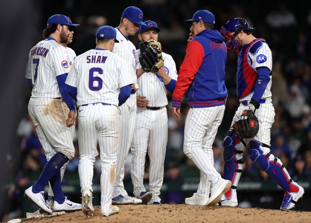 Chicago Cubs manager Craig Counsell (second from right) meets with relief pitcher Chris Flexen and his team on the mound in the 11th inning of a game against the Colorado Rockies at Wrigley Field in Chicago on May 27, 2025. (Chris Sweda/Chicago Tribune)