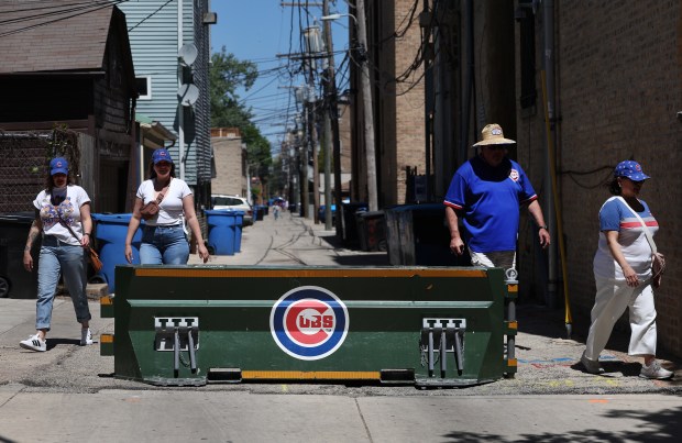 A barrier blocks an alleyway leading to Waveband Avenue as Chicago Cubs fans arrive for a game between the Cubs and the Chicago White Sox at Wrigley Field in Chicago on May 16, 2025. (Chris Sweda/Chicago Tribune)