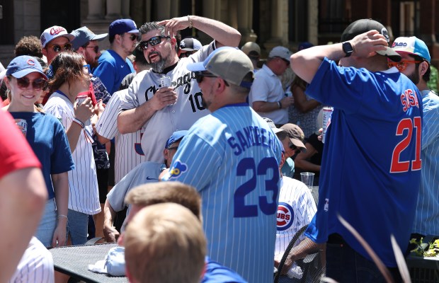 Chicago Cubs and Chicago White Sox fans relax outside of Murphy's Bleachers before a game between the two teams at Wrigley Field in Chicago on May 16, 2025. (Chris Sweda/Chicago Tribune)