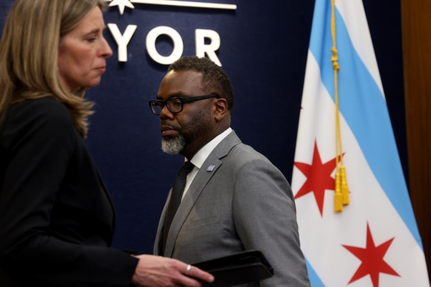 Andrea Kersten, left, the chief administrator of the Civilian Office of Police Accountability (COPA), heads to the podium on April 9, 2024, at City Hall as Mayor Brandon Johnson walks back, to discuss the fatal shooting of Dexter Reed. (Antonio Perez/Chicago Tribune)