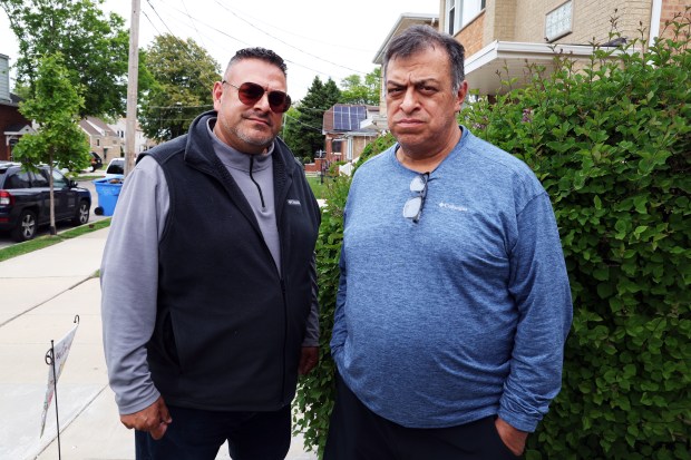 Fernando Ochoa, left, and his brother Alberto Ochoa stand for a portrait on May 27, 2025, after the recent death of their mother, Maria Ochoa, who was struck and killed while walking by a car involved in a collision at Archer and Laramie avenues in Chicago. (Terrence Antonio James/Chicago Tribune)